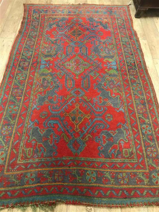 An Ushak Turkish carpet, handwoven with wool and goat hair, red ground, circa 1900 275cm x 162cm